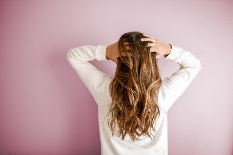 woman touching her hair